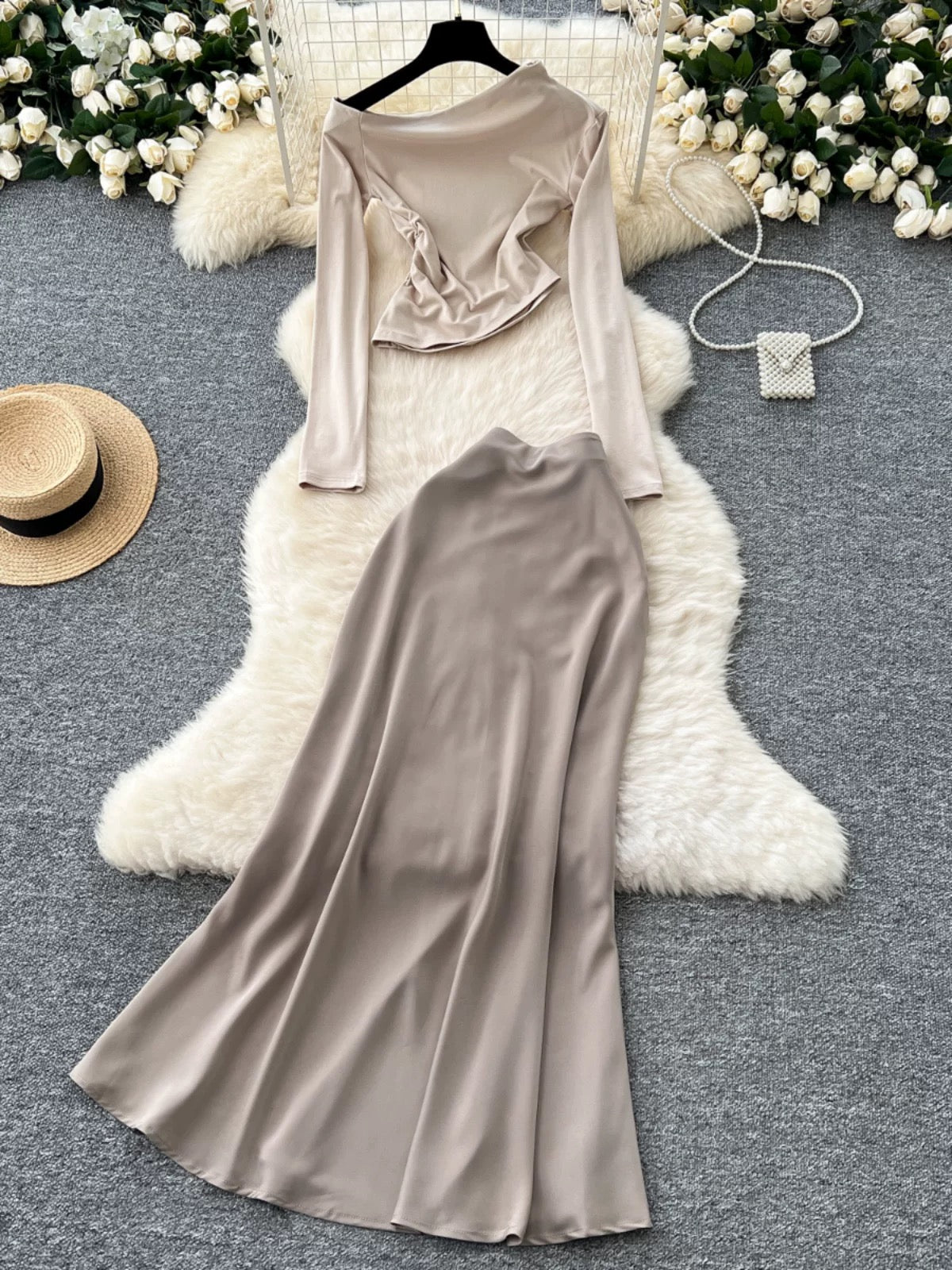 New sophisticated two-piece women's outfit: a high-quality off-shoulder long-sleeved slim-fit T-shirt and a high-waisted satin skirt.
