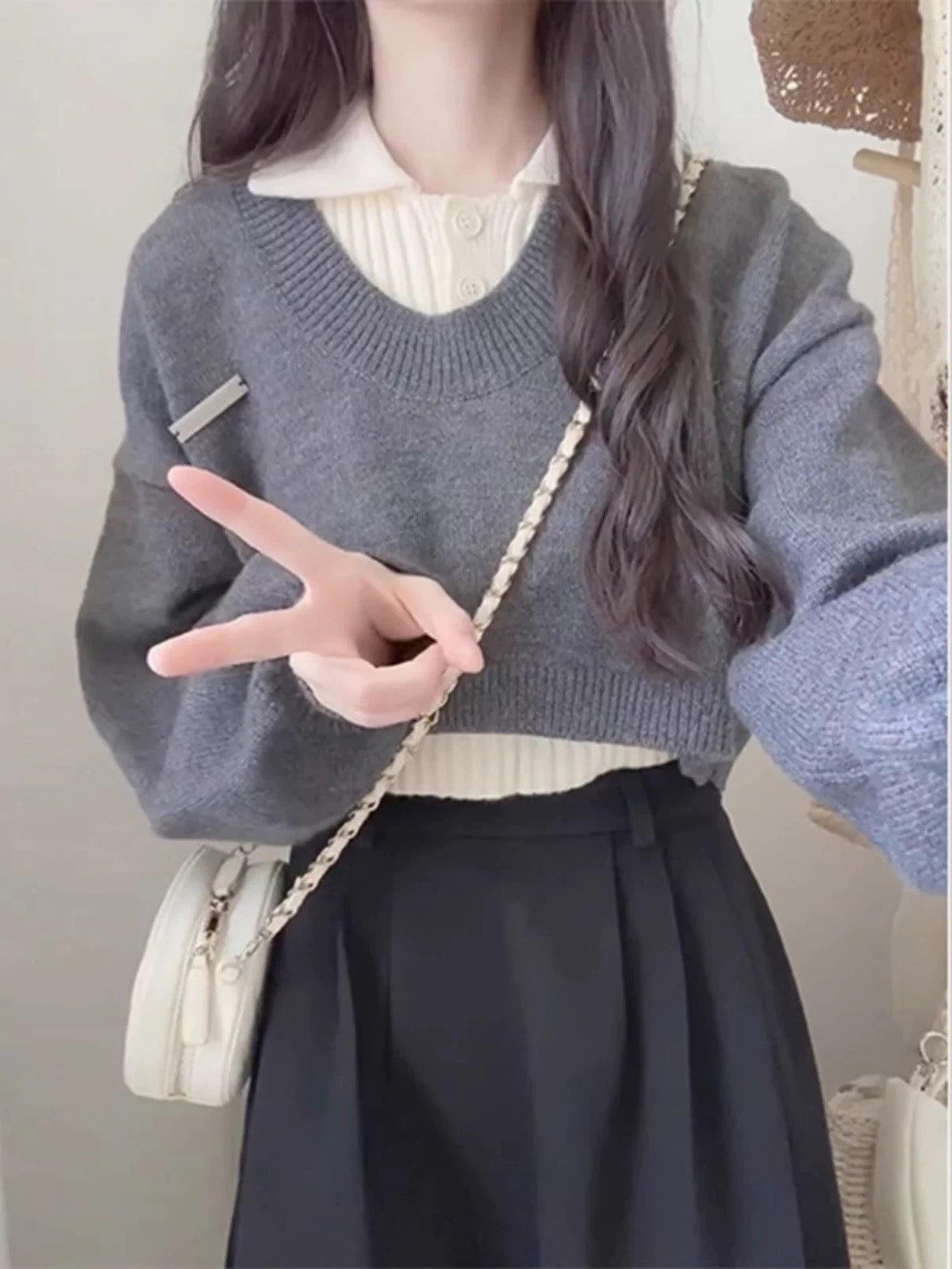 Korean-style preppy early autumn outfit: three-piece set with collared knit sweater layered under a skirt, perfect for petite women looking younger.
