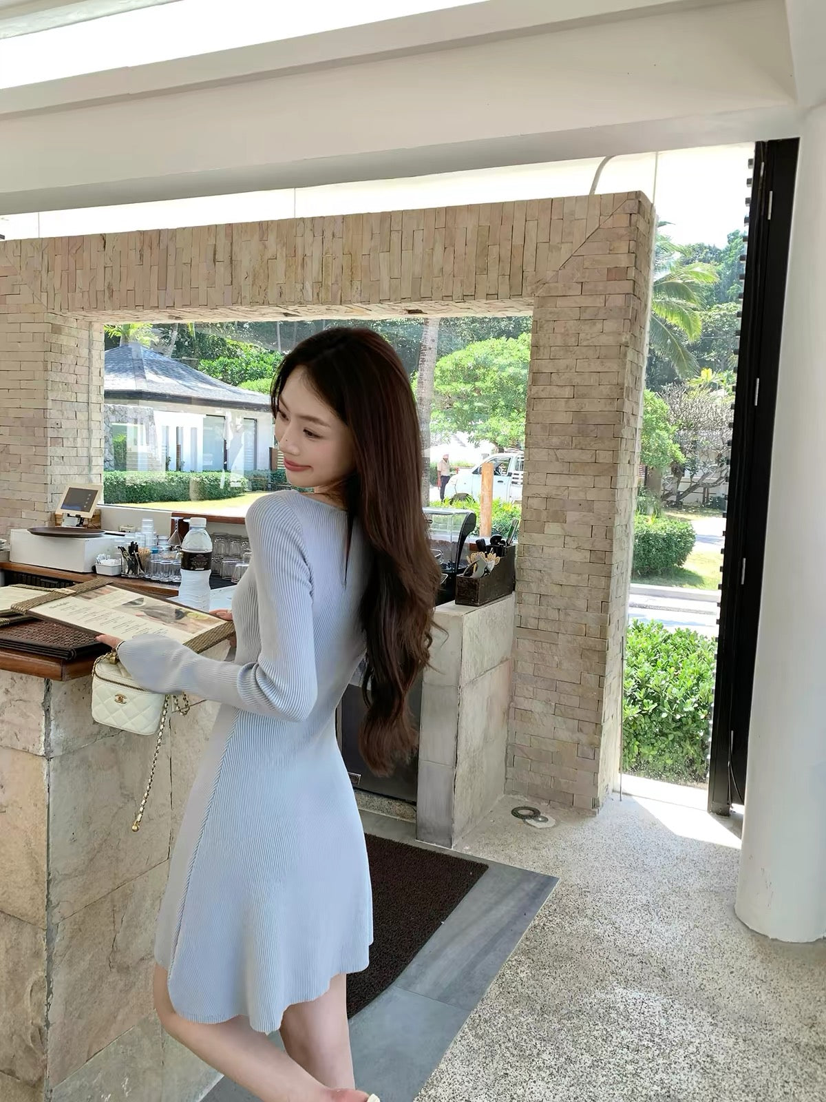 pusumede — A charming, fitted A-line knit mini dress featuring a French-style round neck and long sleeves; designed to flatter the waist and exude an elegant, alluring vibe.