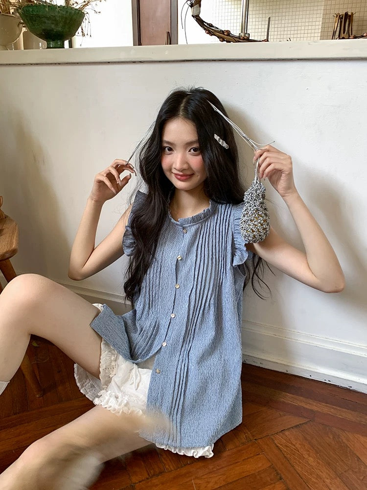 Find the perfect blue sleeveless shirt with ruffled trim for women, a stunning new summer 2026 design, featuring a unique and stylish cut.