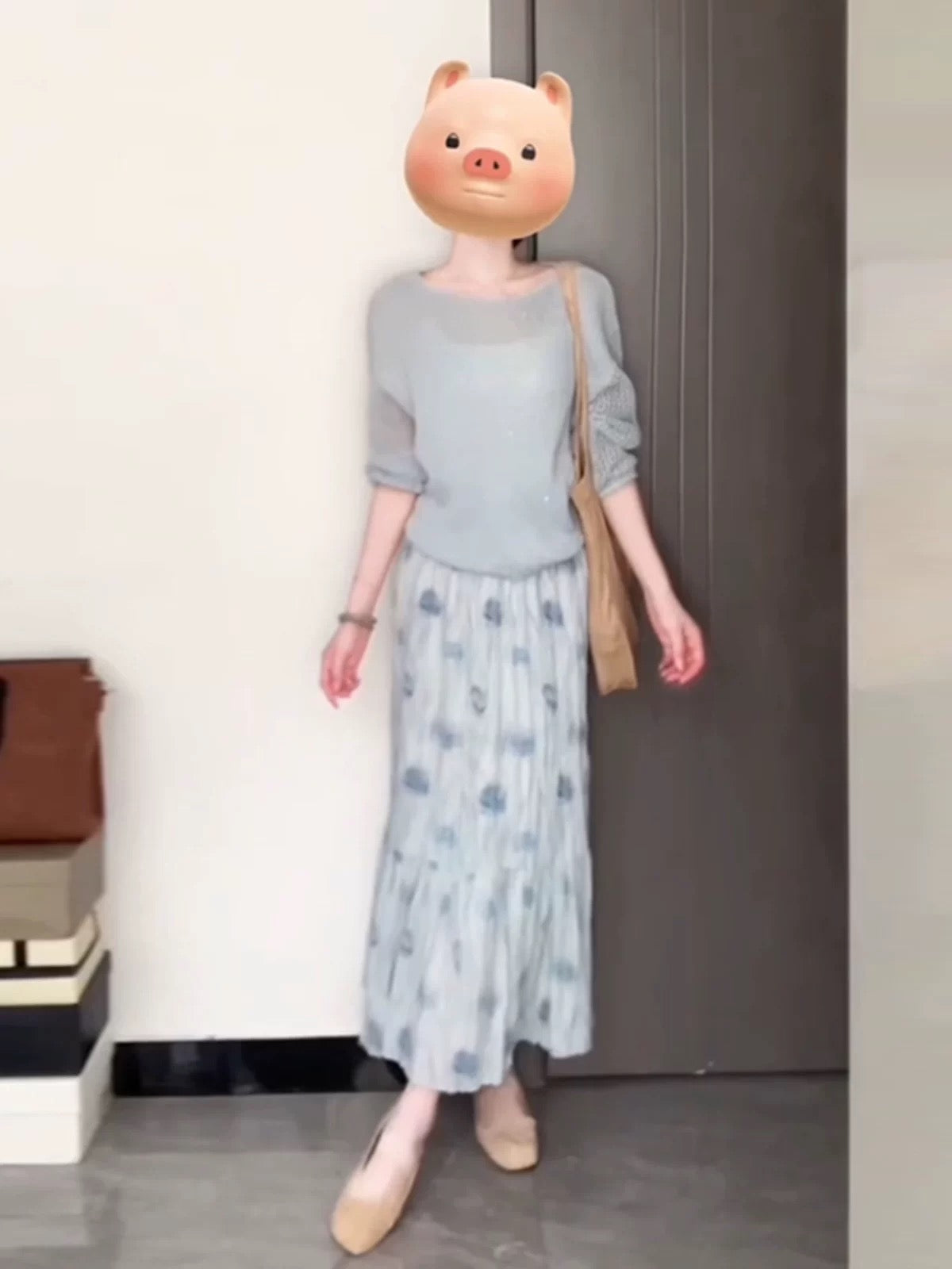 A soft and gentle knitted cardigan and blue floral print midi skirt set for early autumn, exuding elegance.