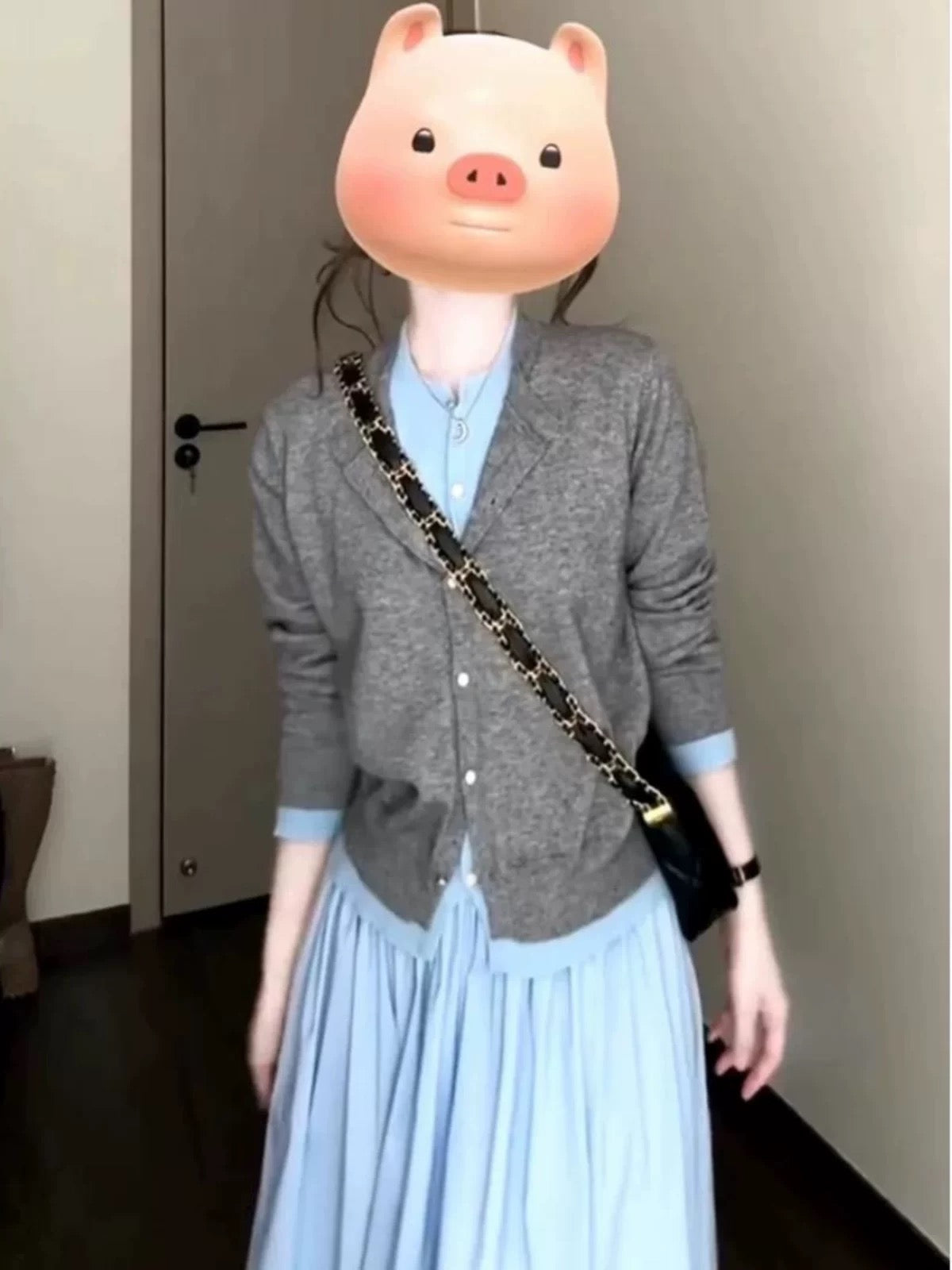 Korean-style early autumn outfit: a gray two-piece knitted cardigan, top, and skirt set for women, exuding elegance and youthful charm.