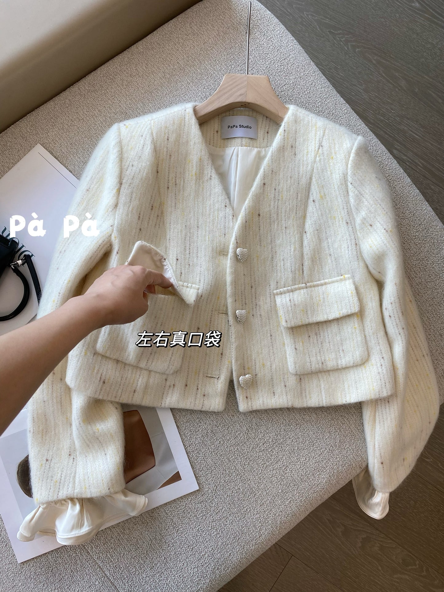 Exquisite and luxurious wool knit cardigan with heart-shaped buttons and detachable ruffled sleeves, featuring a V-neck design.
