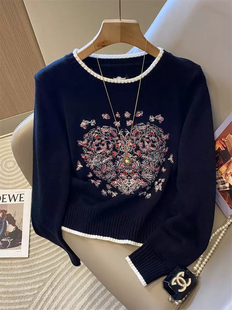 Heavy-duty butterfly and heart embroidered knit sweater for women, autumn and winter 2025 new style, white soft and smooth color-blocked round neck top.