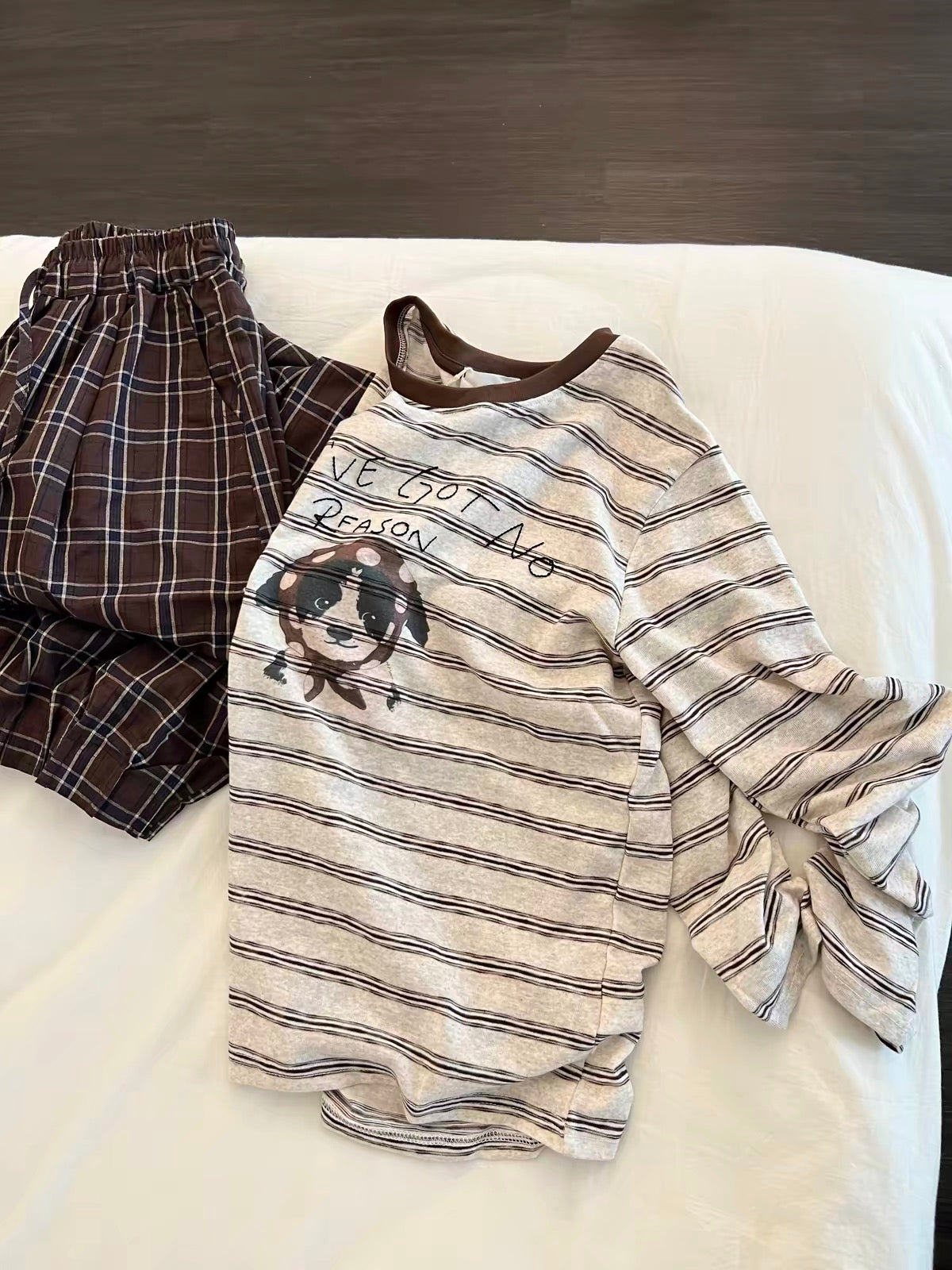 Korean-style relaxed-fit long-sleeved pajama set for women: features a striped top with a puppy print and plaid trousers—suitable for lounging or casual wear.