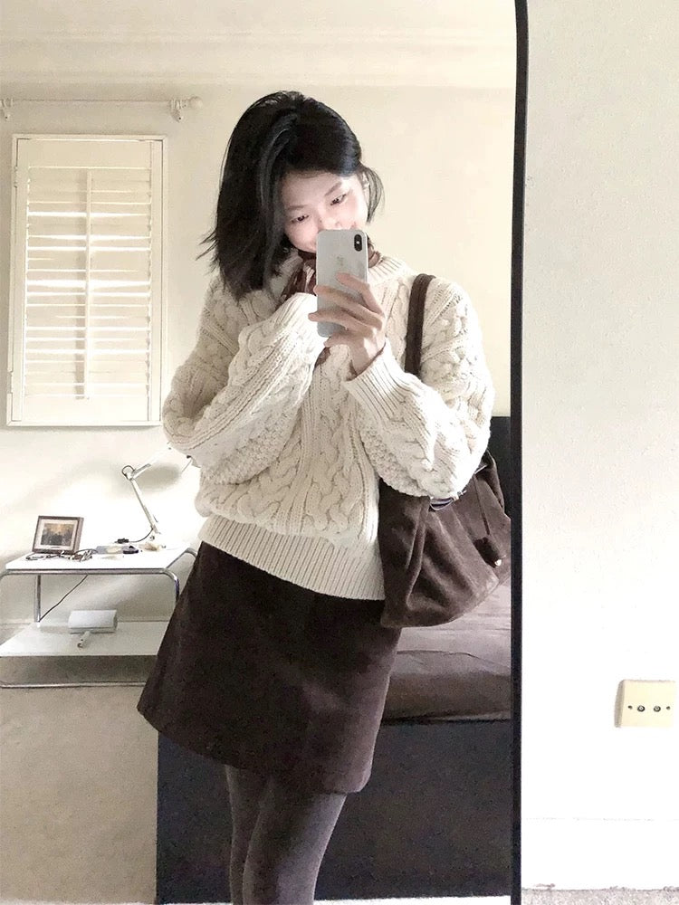 A sophisticated two-piece winter outfit: a preppy Korean-style cable knit sweater and skirt set.