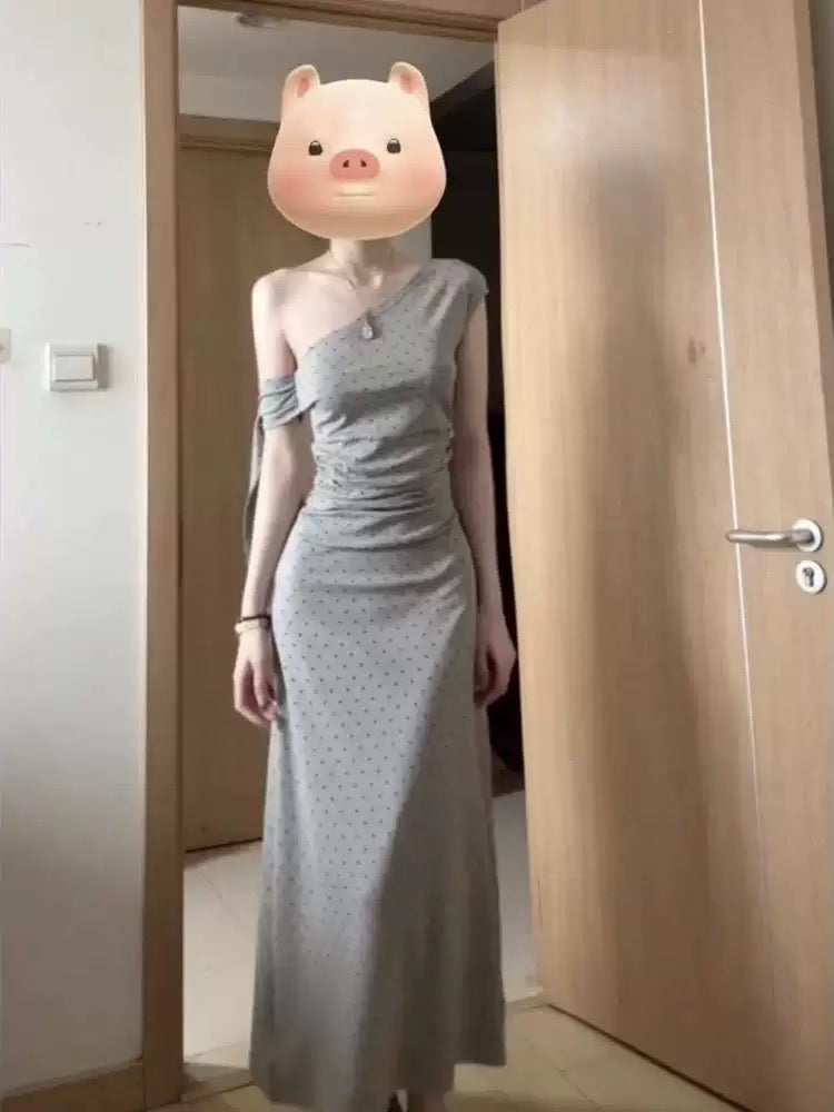 Sophisticated grey off-shoulder dress with a unique, minimalist design; a new summer 2025 style; fitted waist and elegant long dress.