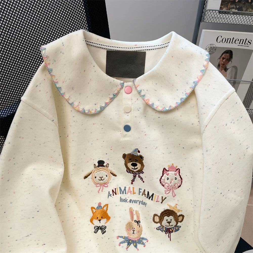Artistic, cute, youthful-looking sweatshirt with a Peter Pan collar, perfect for petite women, perfect for autumn. Features colorful cartoon embroidery.