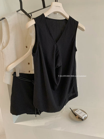 Elegant sleeveless draped-neck top with a high-waisted A-line skirt. Includes a belt and built-in safety shorts for a chic, polished look.