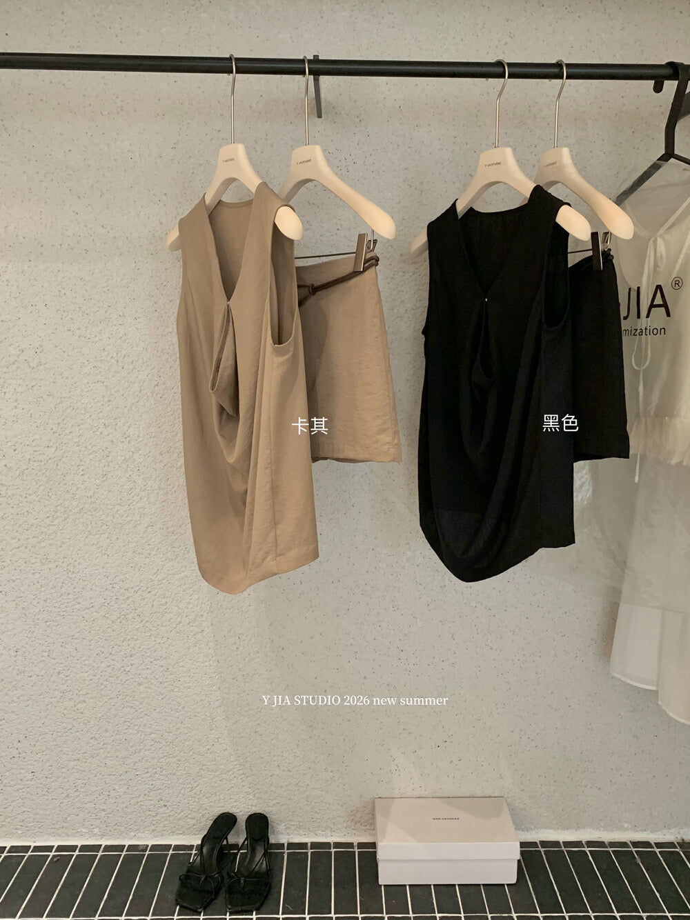 Elegant sleeveless draped-neck top with a high-waisted A-line skirt. Includes a belt and built-in safety shorts for a chic, polished look.