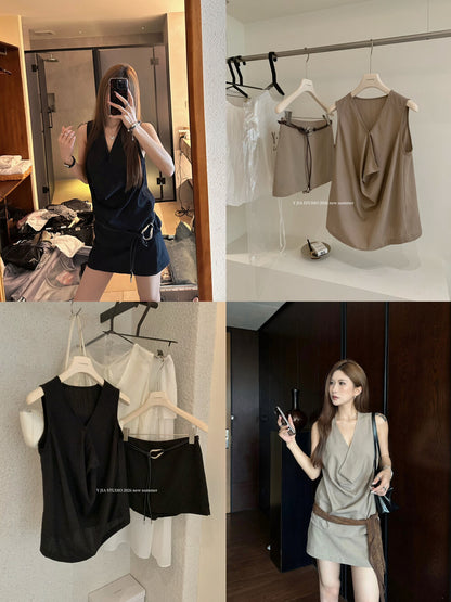 Elegant sleeveless draped-neck top with a high-waisted A-line skirt. Includes a belt and built-in safety shorts for a chic, polished look.