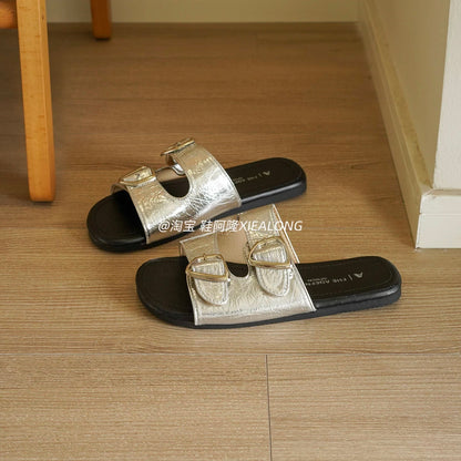 French-style black double-buckle flat slides for women – 2026 summer new arrival featuring metal buckles, suitable for vacation and beach wear.