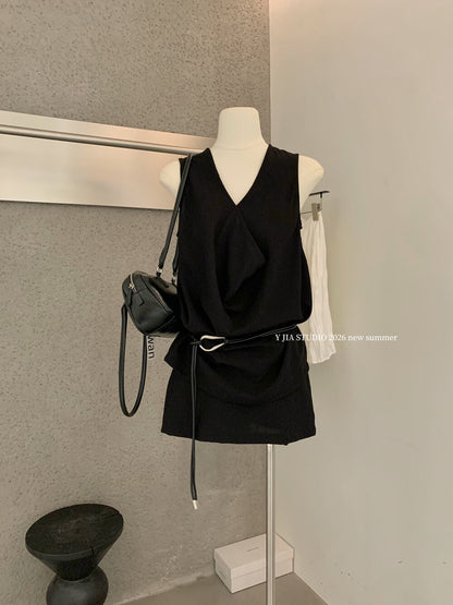 Elegant sleeveless draped-neck top with a high-waisted A-line skirt. Includes a belt and built-in safety shorts for a chic, polished look.