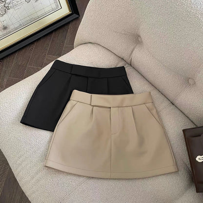 Khaki/black high-waisted A-line skort with a blazer-inspired look—snatched waist, long legs, total fall vibe. 🖤🤎