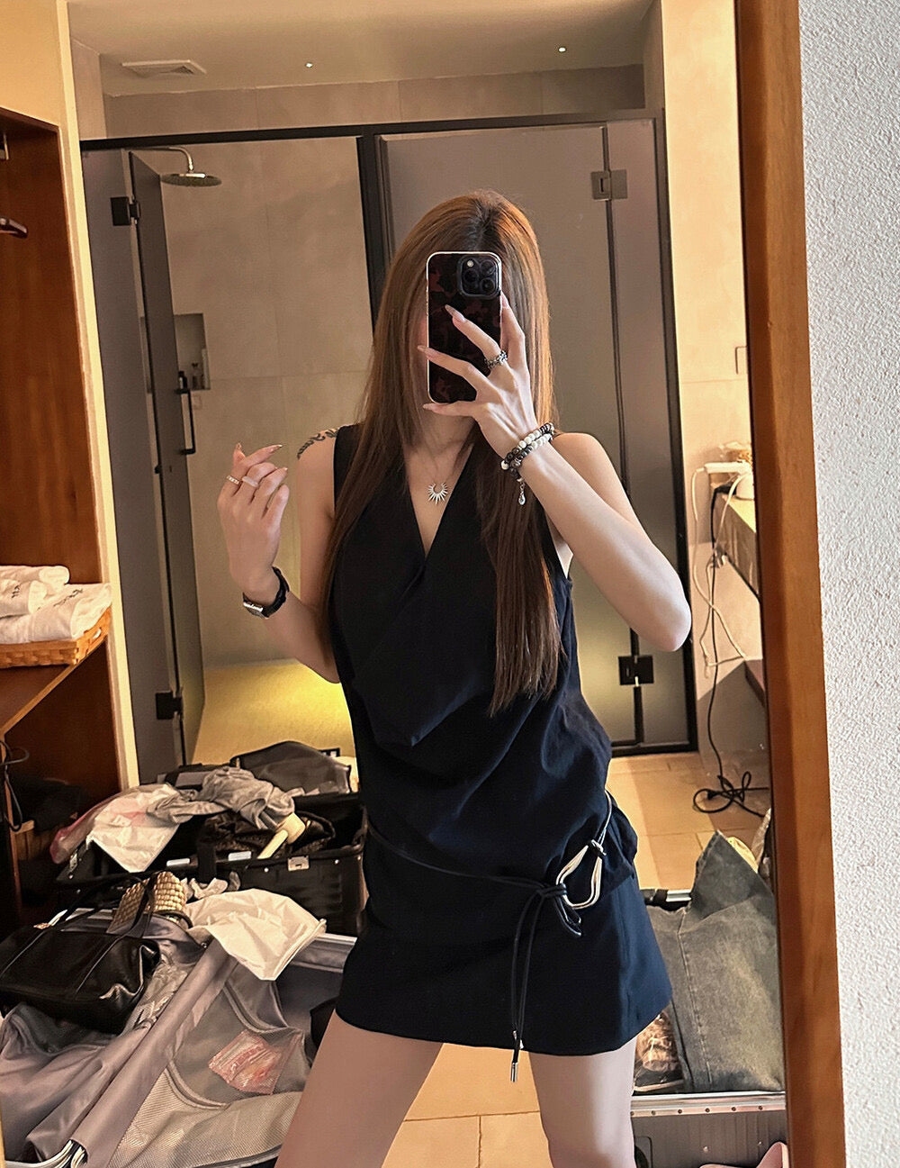 Elegant sleeveless draped-neck top with a high-waisted A-line skirt. Includes a belt and built-in safety shorts for a chic, polished look.