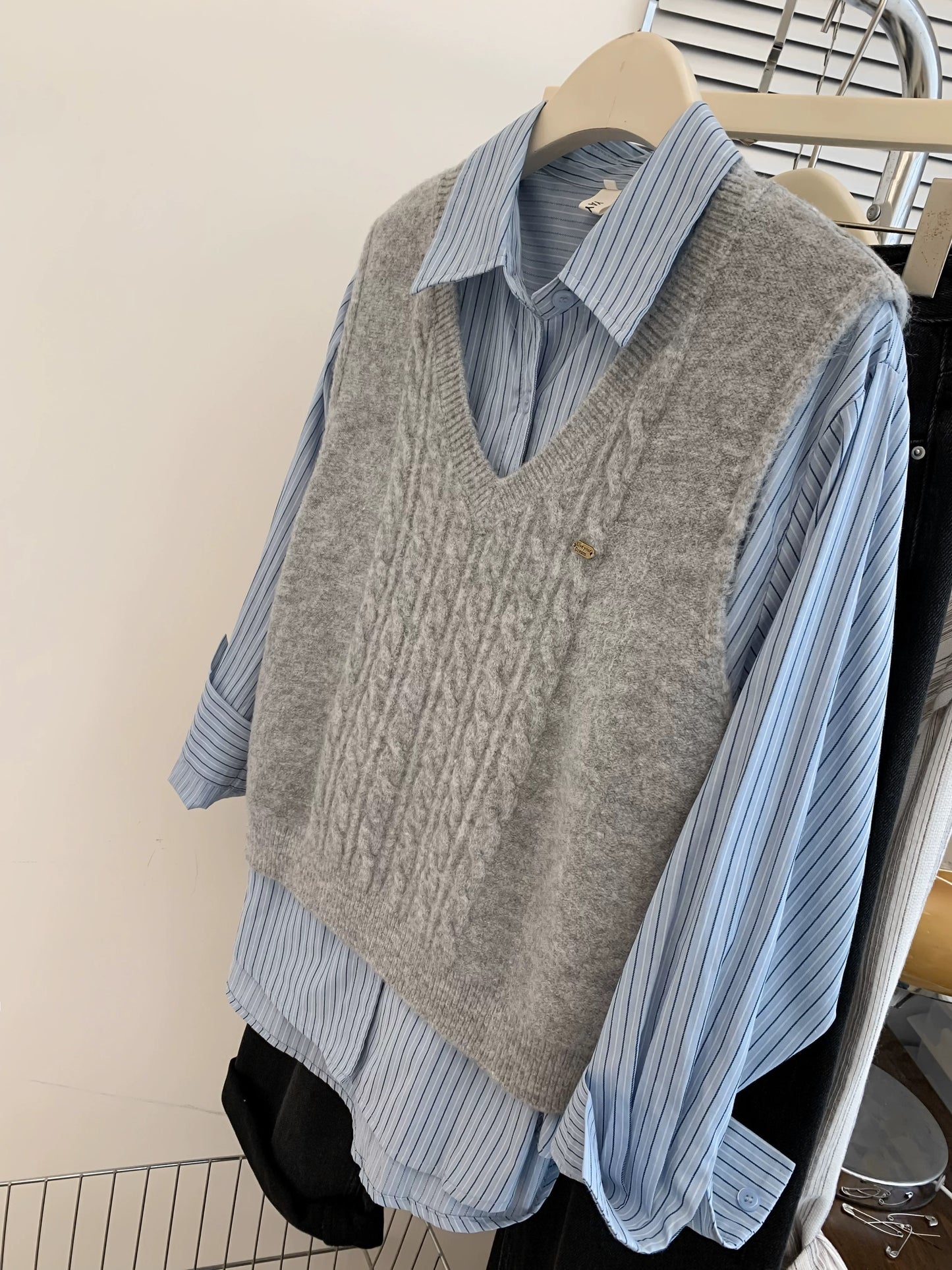 Gray V-neck sweater vest for women in spring and autumn. Small shirt with knitted vest. Layered two-piece spring outfit