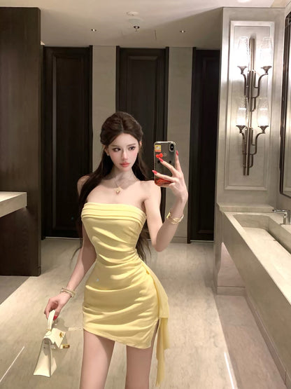 Women's off-shoulder, strapless, form-fitting dress—a stylish, sexy, and elegant piece featuring an open-back design, perfect for the early autumn season.