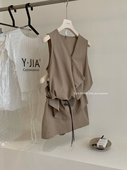 Elegant sleeveless draped-neck top with a high-waisted A-line skirt. Includes a belt and built-in safety shorts for a chic, polished look.