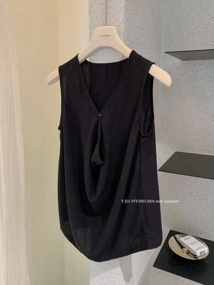 Elegant sleeveless draped-neck top with a high-waisted A-line skirt. Includes a belt and built-in safety shorts for a chic, polished look.