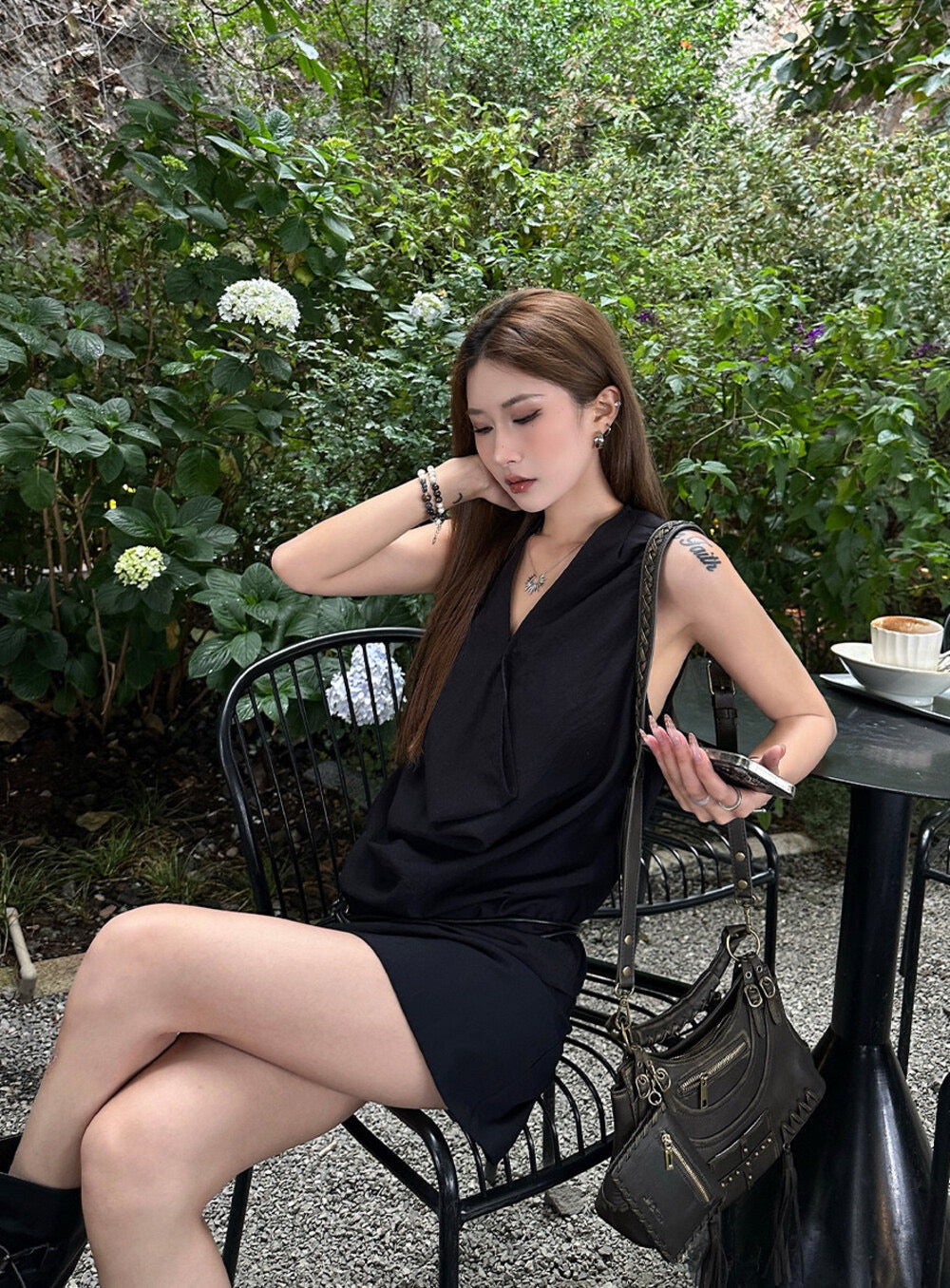 Elegant sleeveless draped-neck top with a high-waisted A-line skirt. Includes a belt and built-in safety shorts for a chic, polished look.