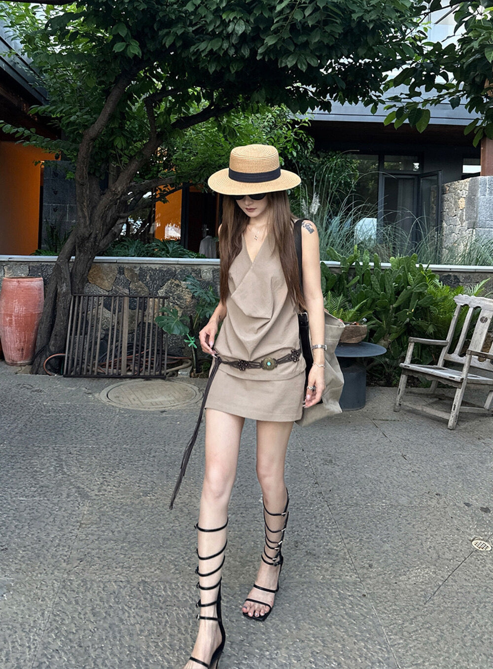Elegant sleeveless draped-neck top with a high-waisted A-line skirt. Includes a belt and built-in safety shorts for a chic, polished look.