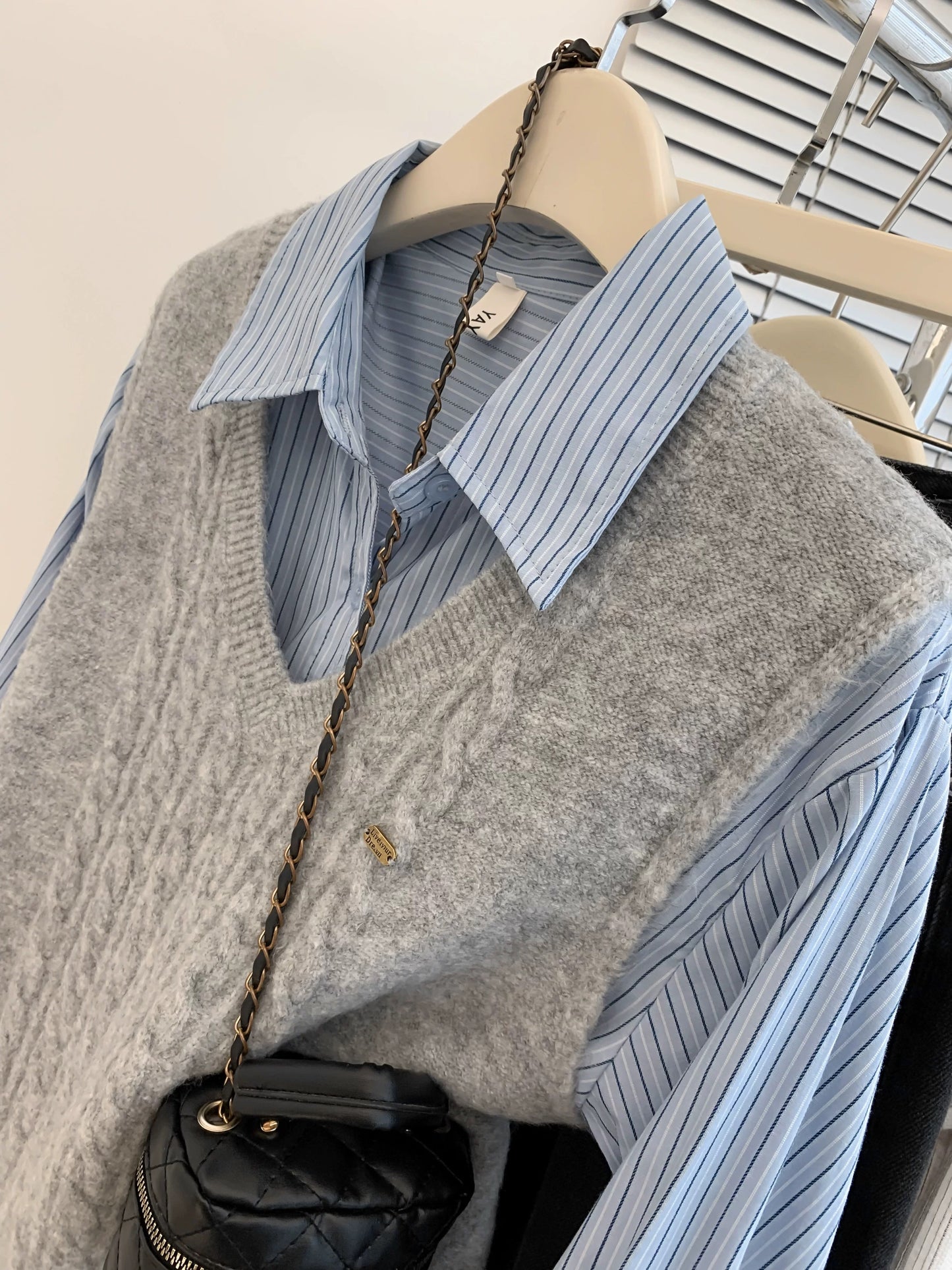 Gray V-neck sweater vest for women in spring and autumn. Small shirt with knitted vest. Layered two-piece spring outfit