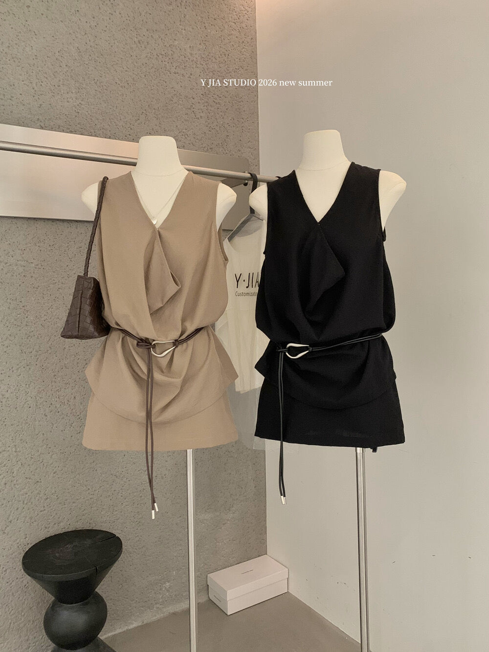 Elegant sleeveless draped-neck top with a high-waisted A-line skirt. Includes a belt and built-in safety shorts for a chic, polished look.