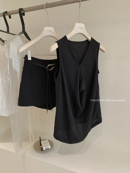 Elegant sleeveless draped-neck top with a high-waisted A-line skirt. Includes a belt and built-in safety shorts for a chic, polished look.