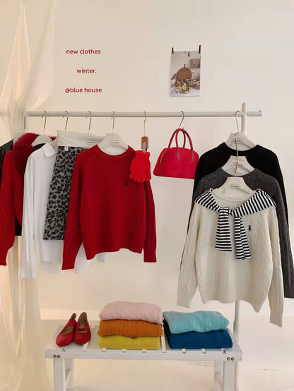 Women's thick, cable-knit pullover sweater featuring embroidery; suitable for layering or wearing as an outer top, with a trendy Korean-style aesthetic.