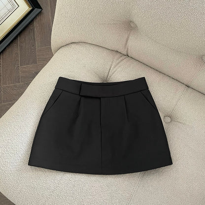 Khaki/black high-waisted A-line skort with a blazer-inspired look—snatched waist, long legs, total fall vibe. 🖤🤎