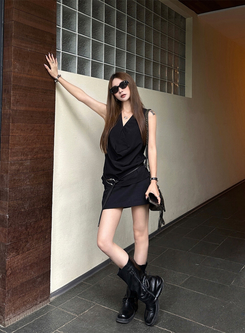 Elegant sleeveless draped-neck top with a high-waisted A-line skirt. Includes a belt and built-in safety shorts for a chic, polished look.