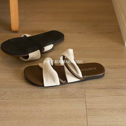Women's French-style casual flat slip-on sandals (2026 Summer New Collection): featuring a crossover strap design, non-slip sole, and a style perfect for vacations and the beach.