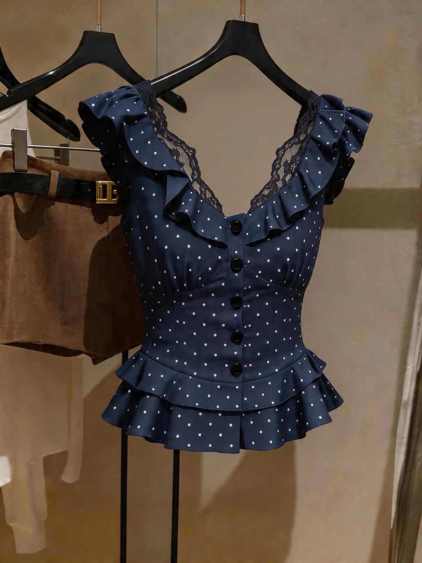 French-style polka-dot V-neck lace-trimmed sleeveless top; a chic, slimming, and stylish blue piece perfect for summer layering