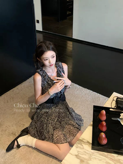 Chien: A black, waist-cinching chiffon dress featuring a mix of leopard and floral prints—evoking a "vintage heiress" vibe that balances innocent charm with alluring style.
