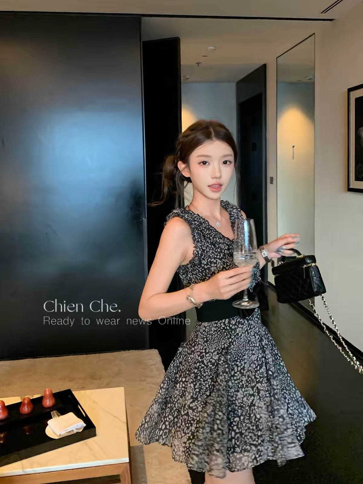 Chien: A black, waist-cinching chiffon dress featuring a mix of leopard and floral prints—evoking a "vintage heiress" vibe that balances innocent charm with alluring style.