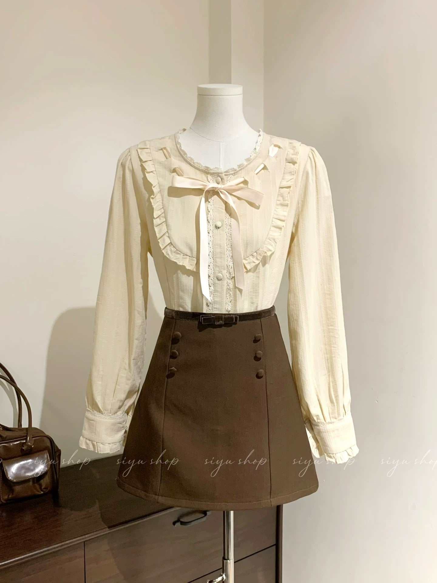 Liquor-filled toffee, apricot pink bow blouse with brown patchwork skirt, a complete autumn/winter outfit for women.