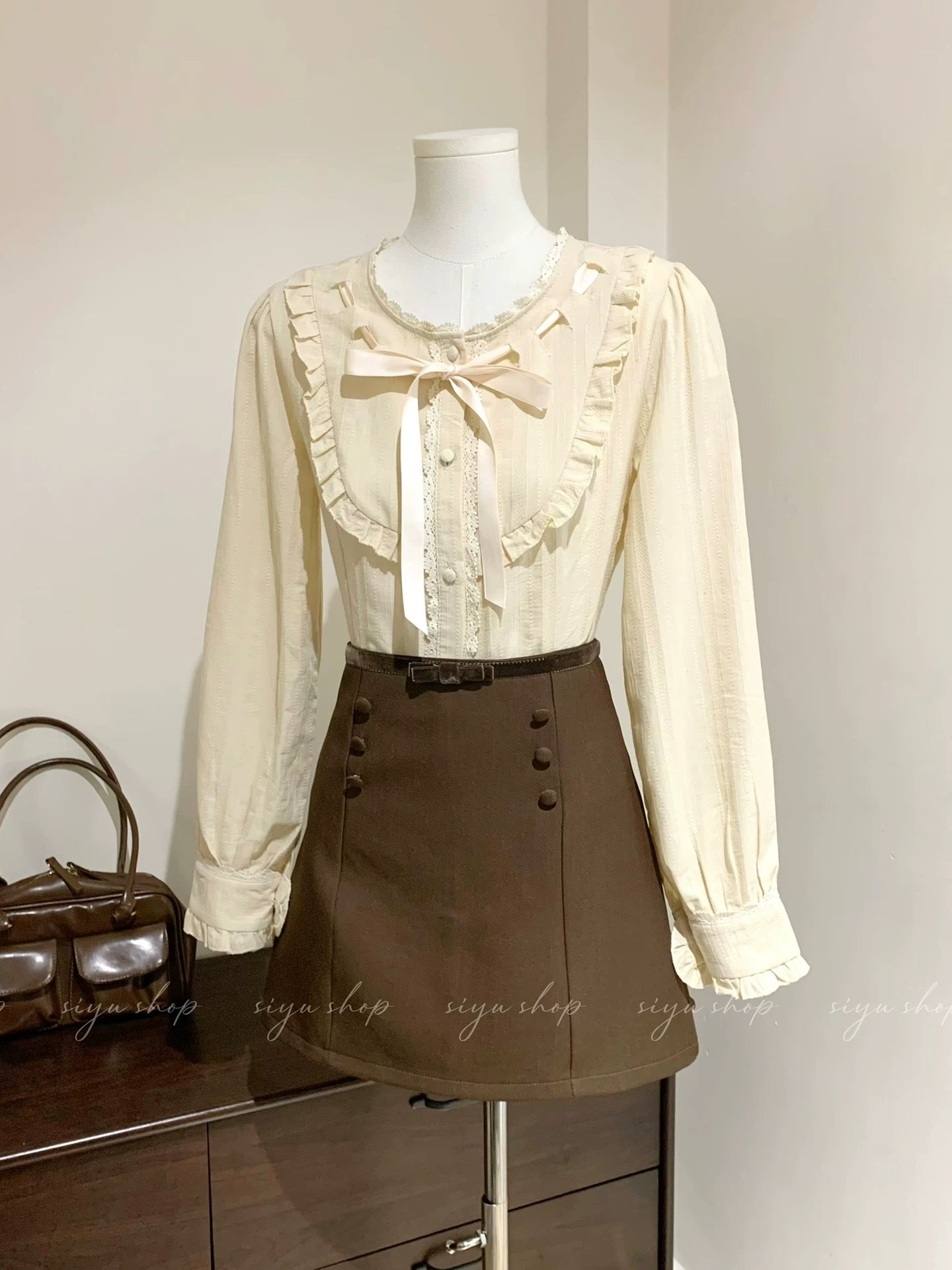 Liquor-filled toffee, apricot pink bow blouse with brown patchwork skirt, a complete autumn/winter outfit for women.