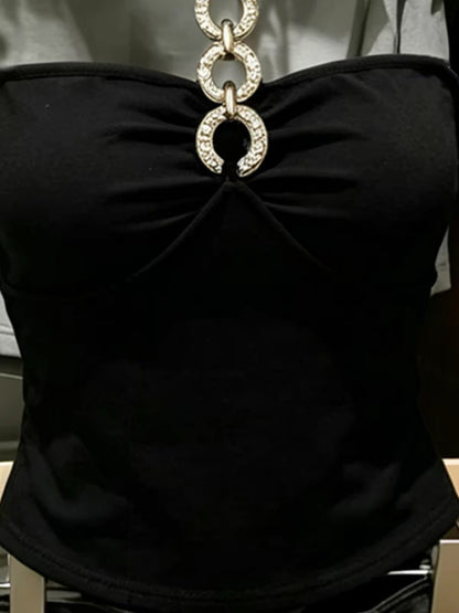 Korean-style black halter-neck tube top featuring cut-out and spliced detailing—a unique, slimming summer piece with a distinctive flair.
