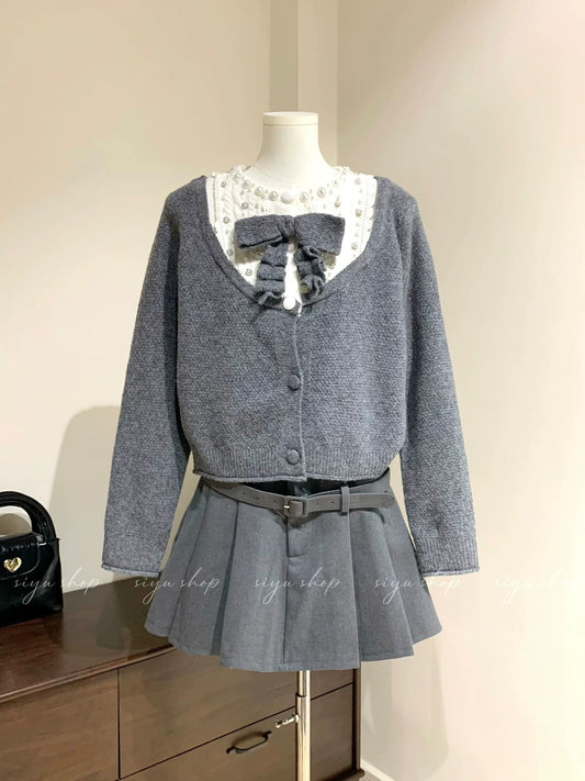 Heavy-duty beaded bow gray faux two-piece top + color-blocked woolen skirt set for elegant women in autumn and winter.