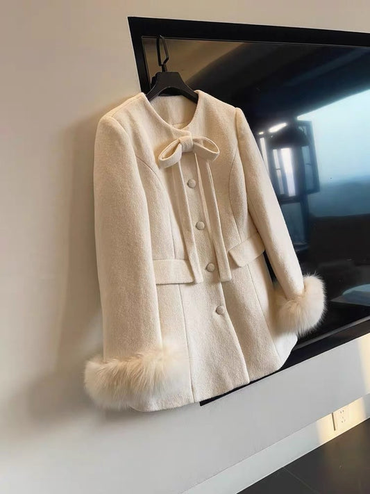 JULY START A sophisticated, elegant mid-length down wool coat with a bow detail and cinched waist.