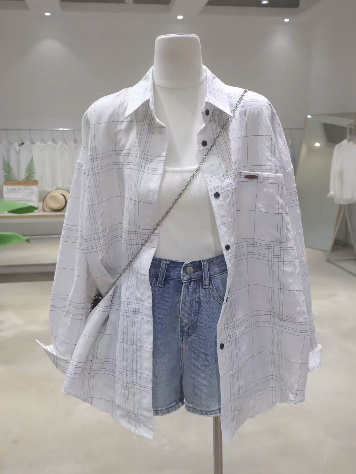 Korean-style breathable cotton plaid long-sleeve shirt for women; loose, mid-length fit; featuring elaborate, dimensional letter embroidery (Summer 2026).