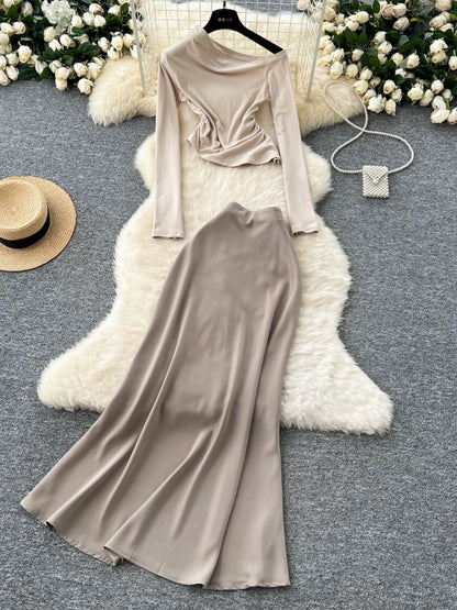 New sophisticated two-piece women's outfit: a high-quality off-shoulder long-sleeved slim-fit T-shirt and a high-waisted satin skirt.