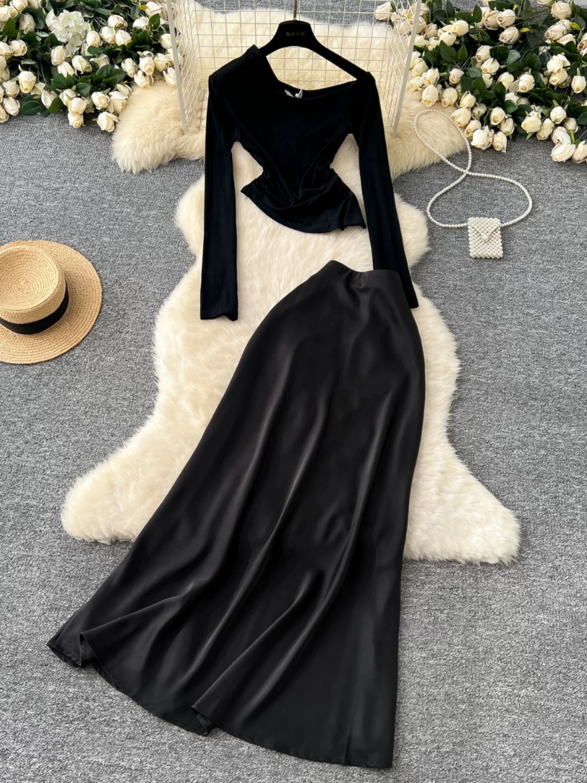 New sophisticated two-piece women's outfit: a high-quality off-shoulder long-sleeved slim-fit T-shirt and a high-waisted satin skirt.