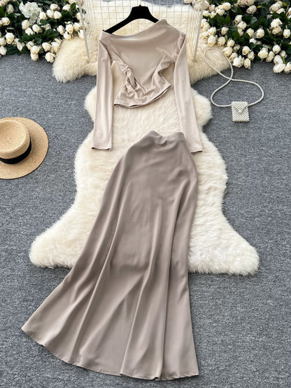 New sophisticated two-piece women's outfit: a high-quality off-shoulder long-sleeved slim-fit T-shirt and a high-waisted satin skirt.