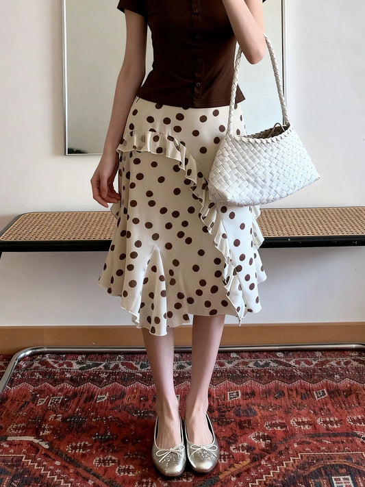 Plus-size yellow irregular ruffle polka dot midi skirt for women, summer French style, high-waisted, elegant, slimming A-line skirt.