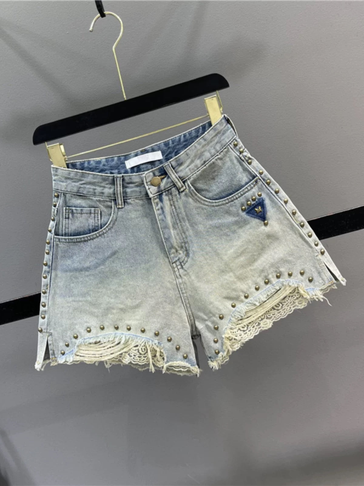 Retro studded lace patchwork denim shorts for women, 2026 summer, high-waisted, slimming A-line, slit wide-leg hot pants.