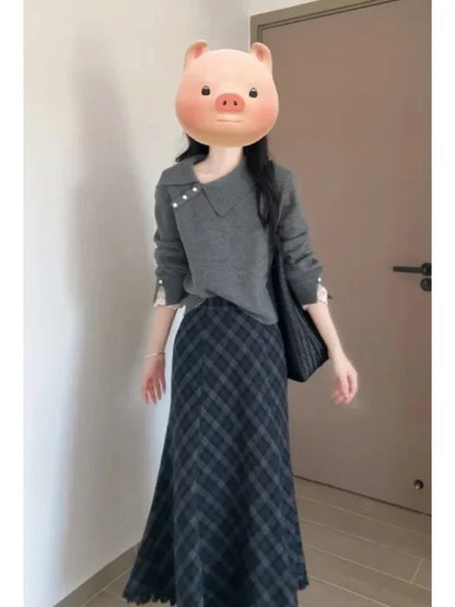 Korean-style autumn/winter outfit: a retro-chic gray sweater and plaid skirt two-piece set.