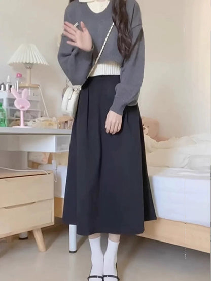 Korean-style preppy early autumn outfit: three-piece set with collared knit sweater layered under a skirt, perfect for petite women looking younger.
