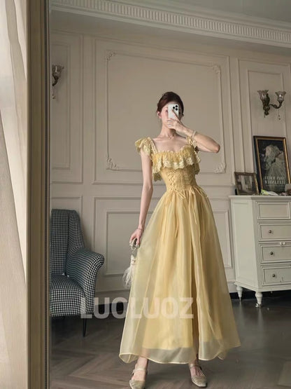 LUOLUOZ "Soft Yellow Dream" – A gentle-style long dress featuring ruffles, a fitted waist, and a wrap-style lace-up design (JF1424).