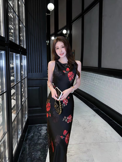 Stunning French-style black floral acetate camisole dress with a V-neck—a new summer arrival featuring a figure-flattering, slim-fit, and elegant long silhouette.